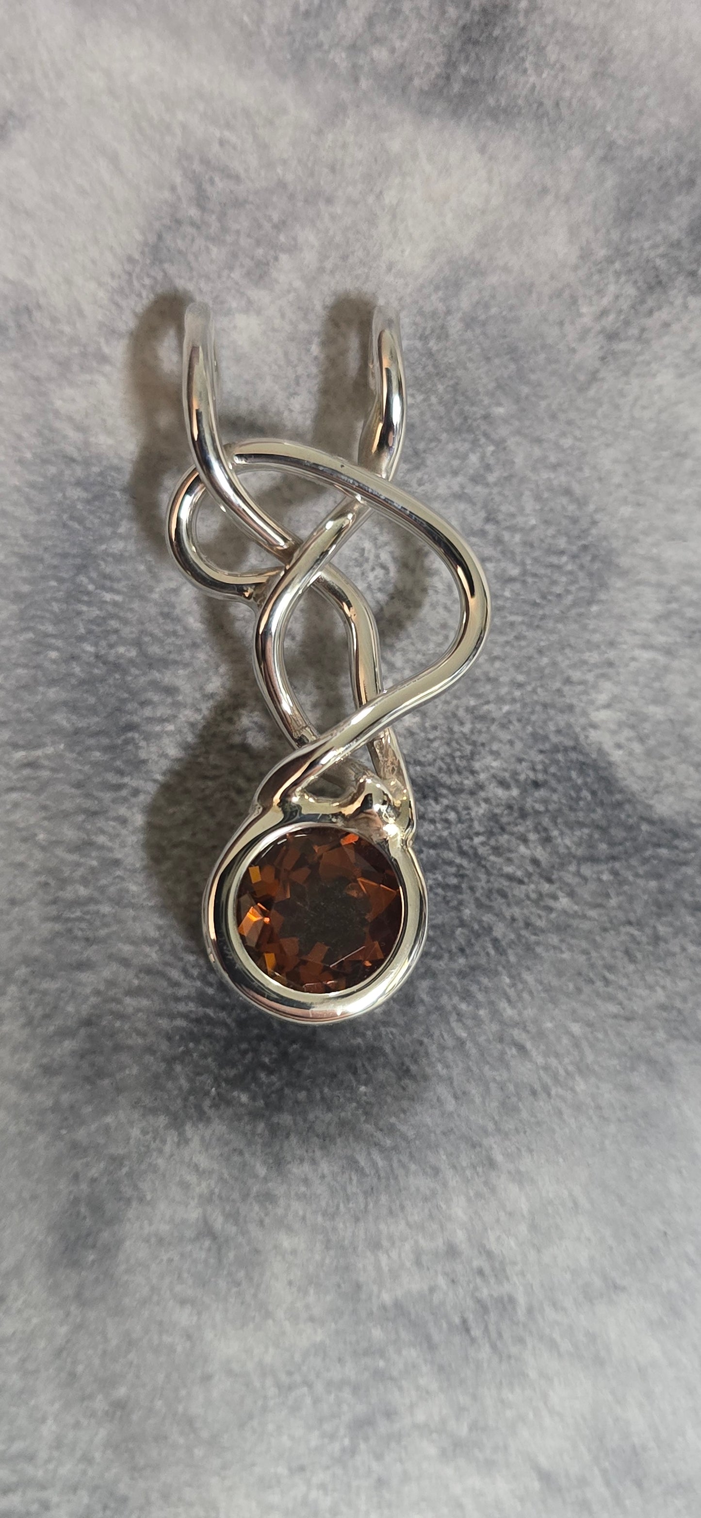 9mm citrine mounted in a sterling silver freeform pendant.