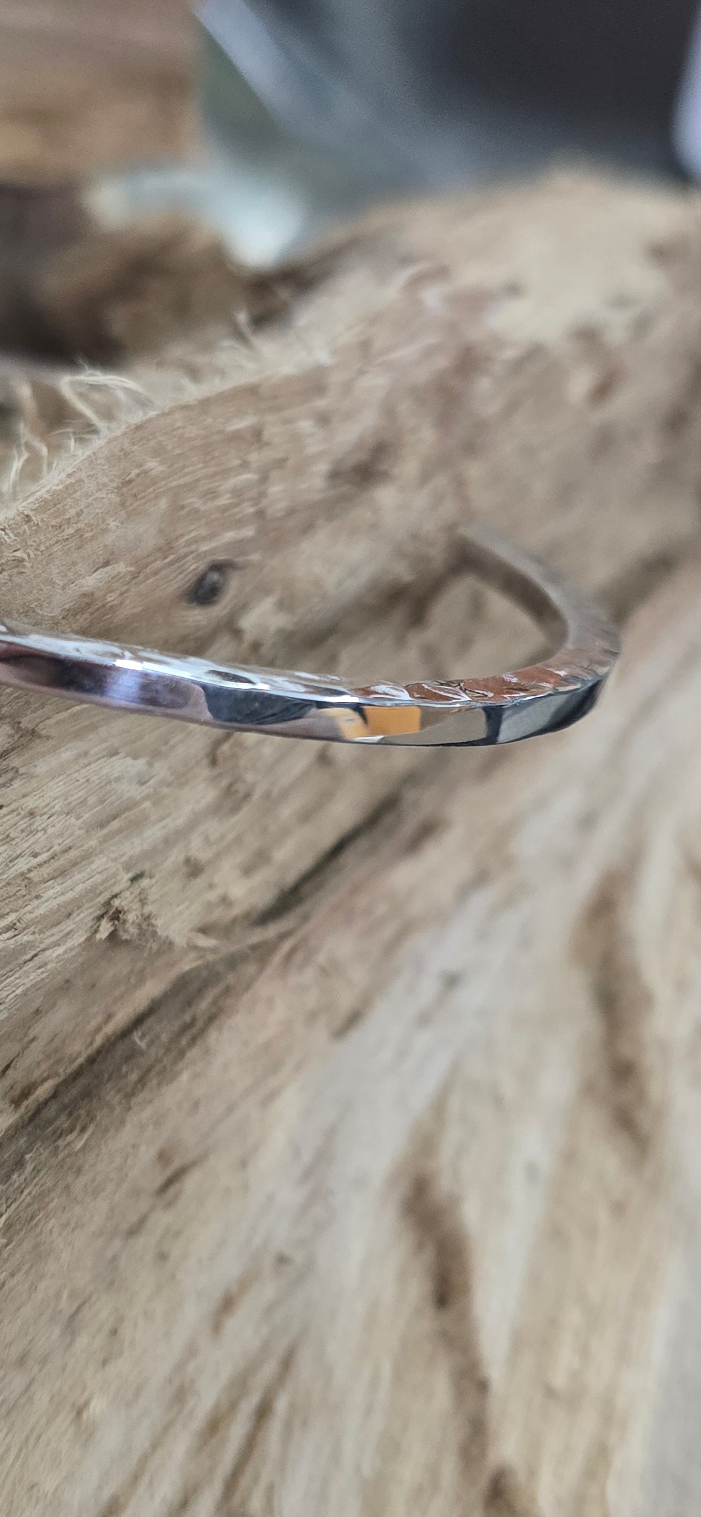 Hammered sterling silver bracelet on the side smooth on the top.