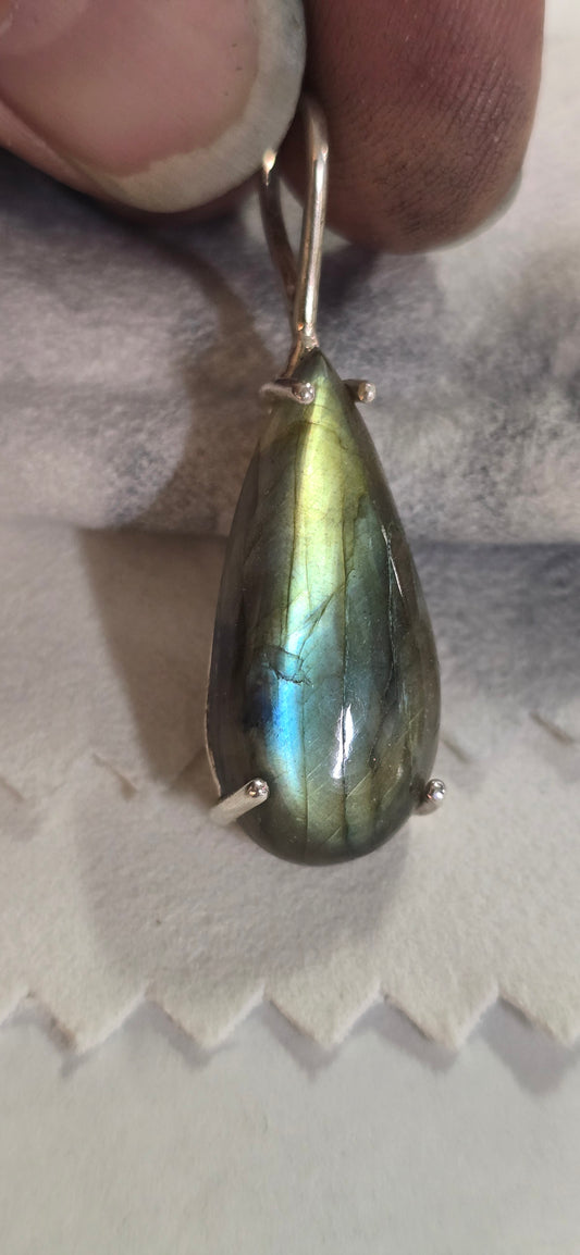 Teardrop shape labradorite mounted in silver pendant.