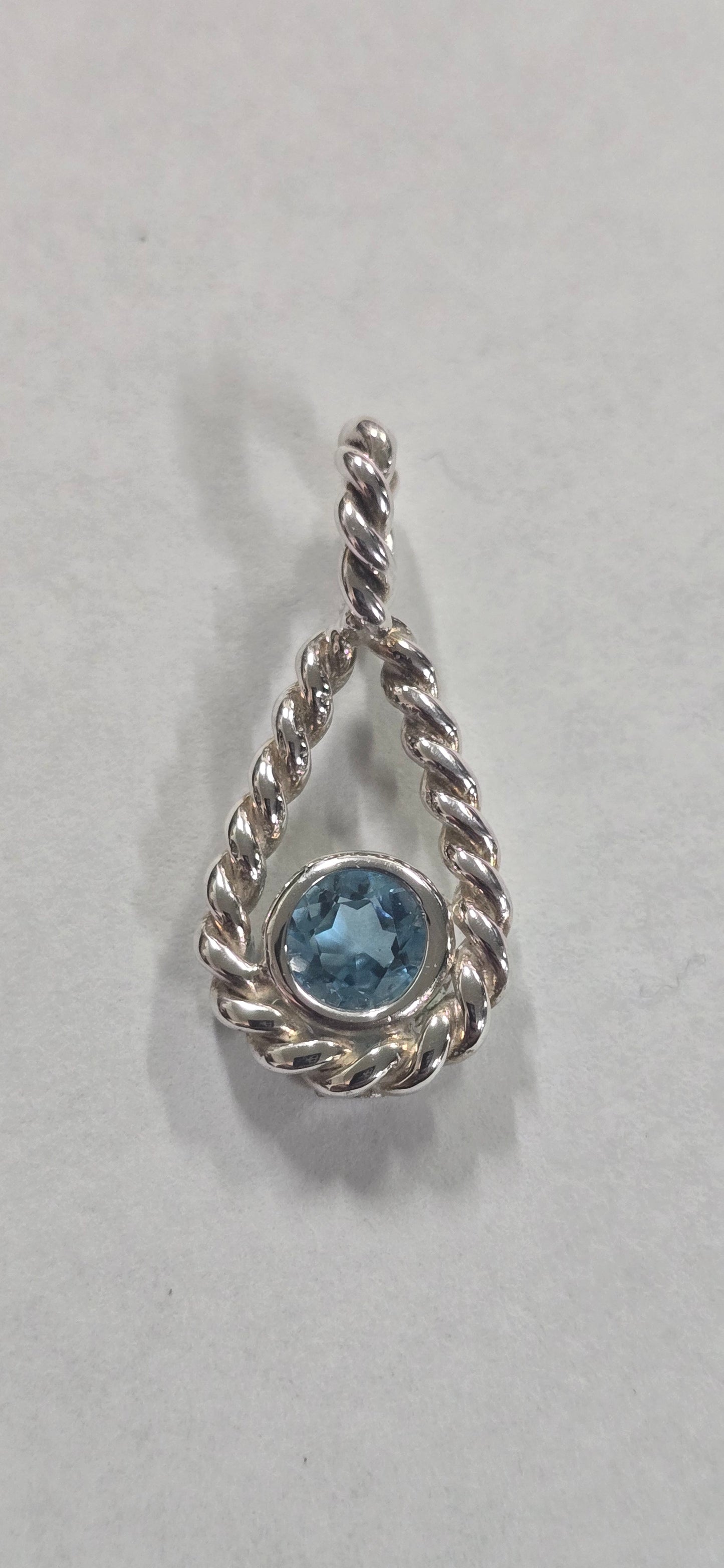 Twisted tear drop with 5mm blue topaz